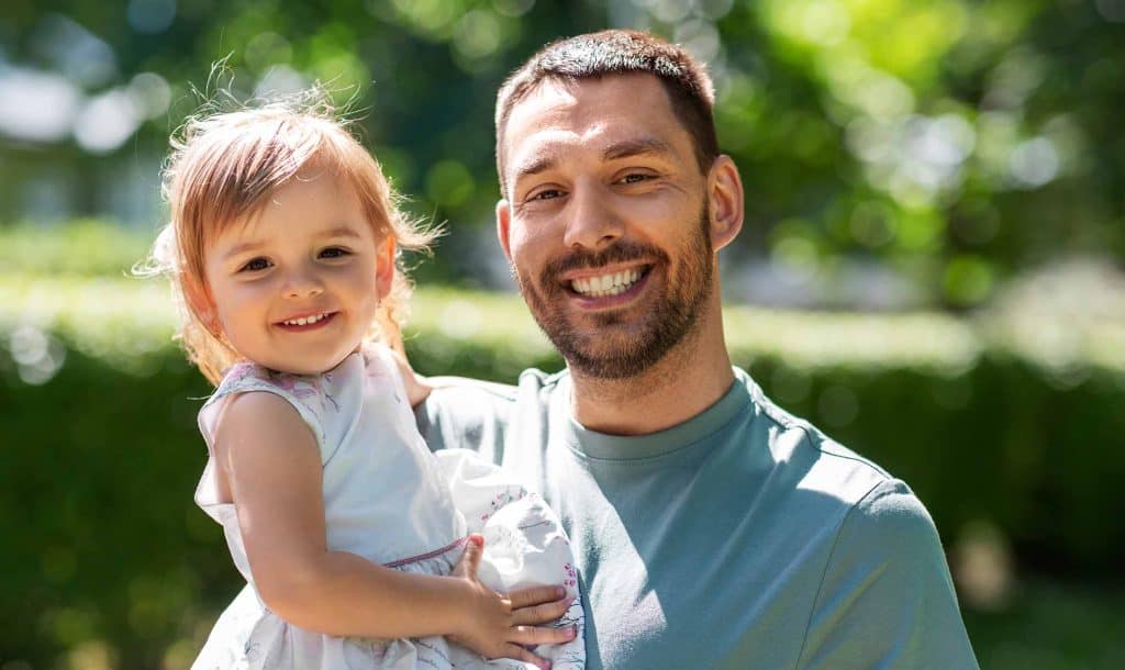 Man Holding Young Daughter